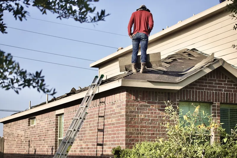Professional roofer working on a residential roof in Innsbrook